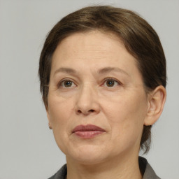 Joyful white adult female with medium  brown hair and grey eyes