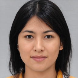 Joyful asian young-adult female with medium  brown hair and brown eyes