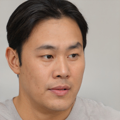 Neutral asian young-adult male with short  brown hair and brown eyes
