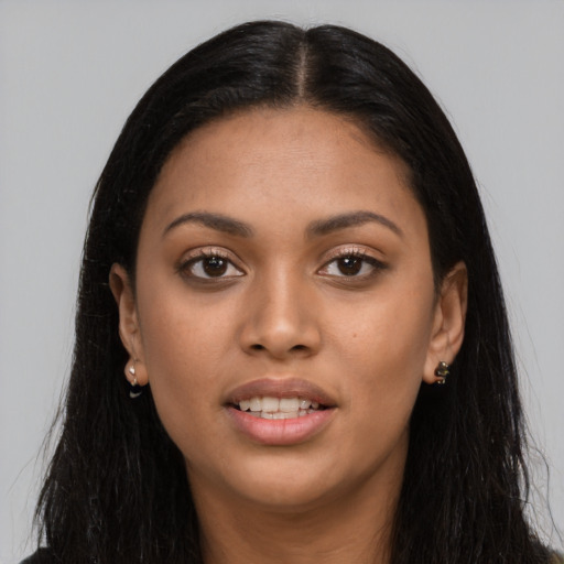 Joyful latino young-adult female with long  black hair and brown eyes