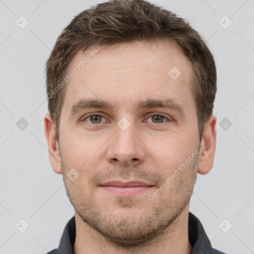 Joyful white young-adult male with short  brown hair and grey eyes