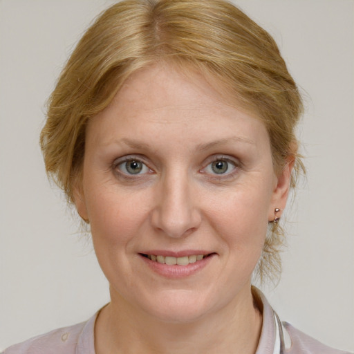 Joyful white adult female with medium  brown hair and blue eyes