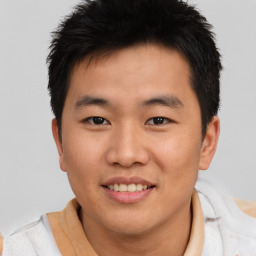 Joyful asian young-adult male with short  brown hair and brown eyes