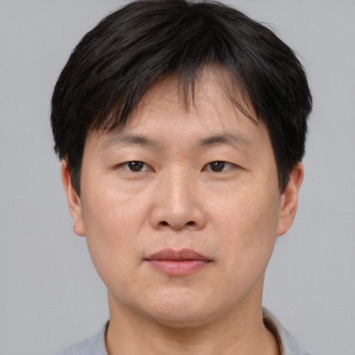 Neutral asian adult male with short  brown hair and brown eyes
