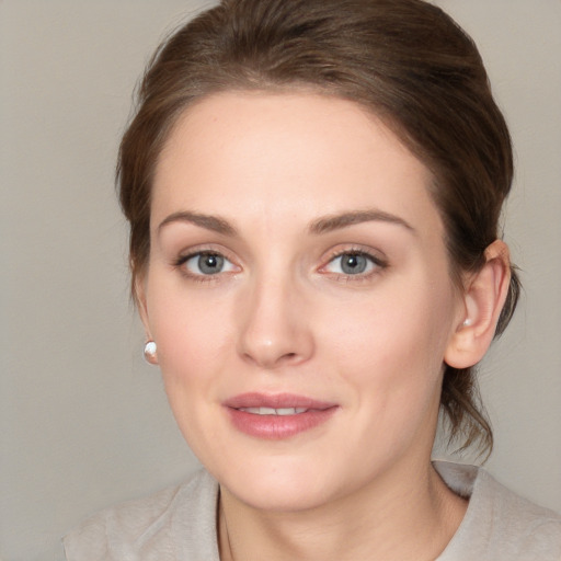 Joyful white young-adult female with medium  brown hair and green eyes