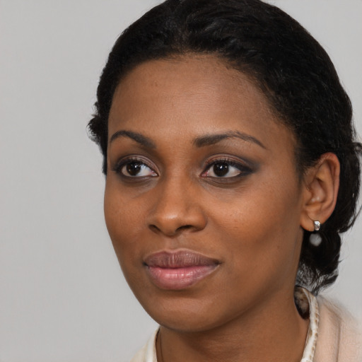 Joyful black young-adult female with medium  brown hair and brown eyes