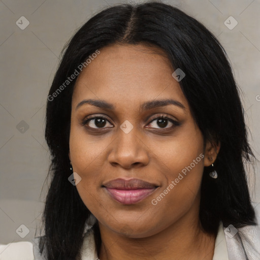 Joyful black young-adult female with long  black hair and brown eyes