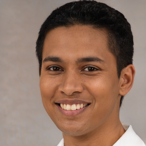 Joyful latino young-adult male with short  brown hair and brown eyes