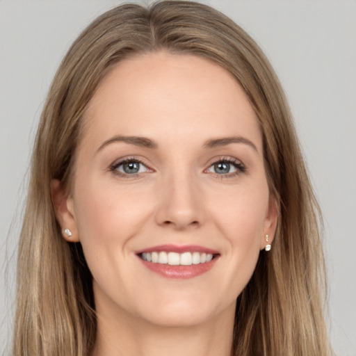 Joyful white young-adult female with long  brown hair and grey eyes