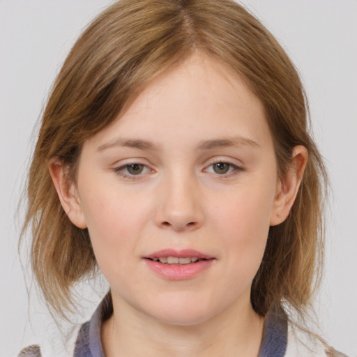 Joyful white child female with medium  brown hair and grey eyes