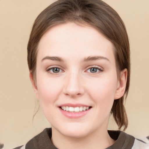 Joyful white young-adult female with medium  brown hair and green eyes