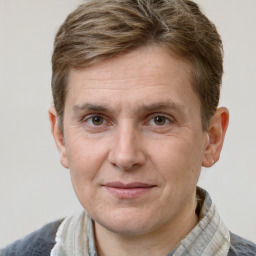 Joyful white adult male with short  brown hair and grey eyes