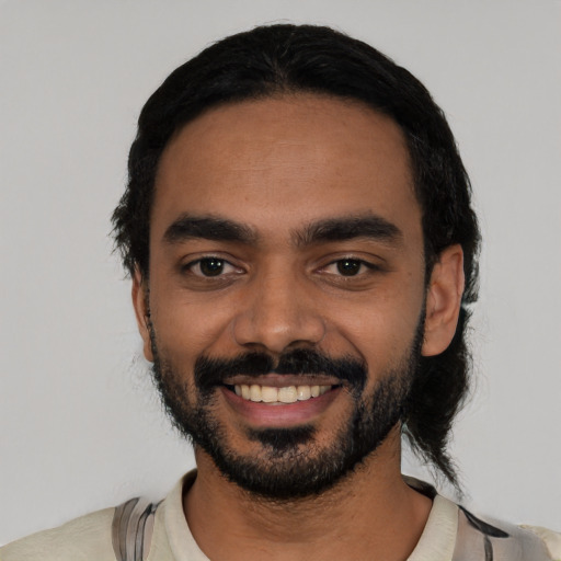 Joyful latino young-adult male with short  black hair and brown eyes