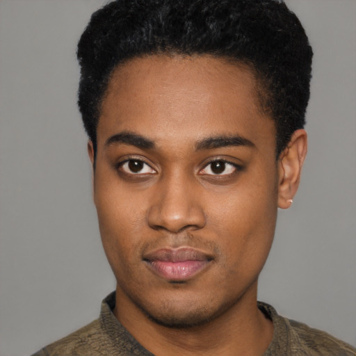 Joyful black young-adult male with short  black hair and brown eyes