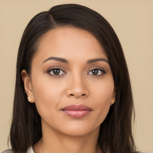 Joyful latino young-adult female with long  brown hair and brown eyes