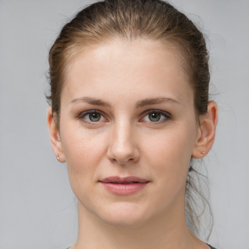 Joyful white young-adult female with medium  brown hair and grey eyes