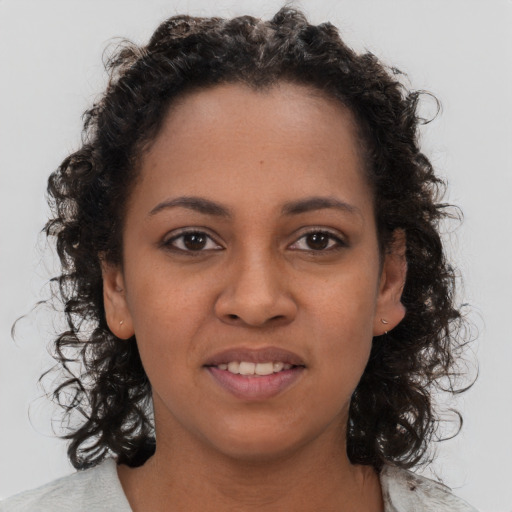 Joyful black young-adult female with medium  brown hair and brown eyes
