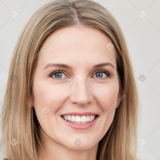 Joyful white young-adult female with long  brown hair and green eyes