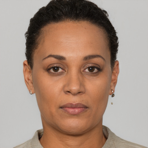 Joyful latino adult female with short  brown hair and brown eyes