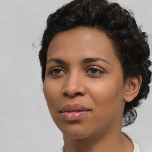 Joyful latino young-adult female with short  black hair and brown eyes