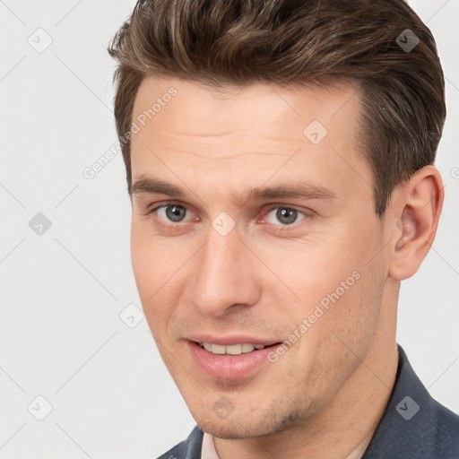 Joyful white young-adult male with short  brown hair and brown eyes