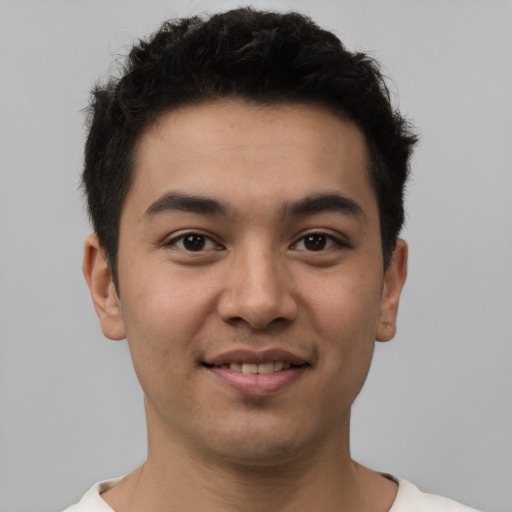 Joyful latino young-adult male with short  brown hair and brown eyes