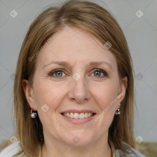 Joyful white adult female with medium  brown hair and blue eyes