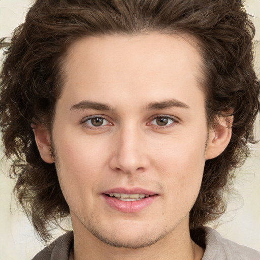 Joyful white young-adult male with medium  brown hair and brown eyes