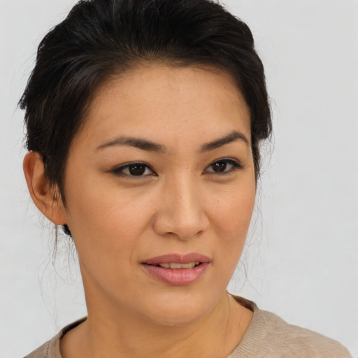 Joyful latino young-adult female with short  brown hair and brown eyes