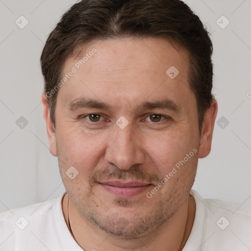 Joyful white adult male with short  brown hair and brown eyes