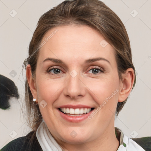 Joyful white adult female with medium  brown hair and grey eyes