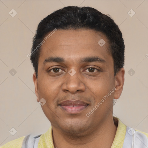 Joyful black young-adult male with short  black hair and brown eyes