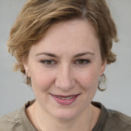 Joyful white young-adult female with medium  brown hair and blue eyes