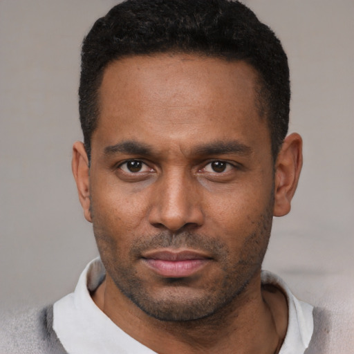 Neutral latino young-adult male with short  black hair and brown eyes