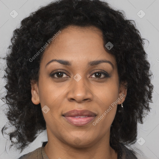 Joyful black adult female with medium  brown hair and brown eyes