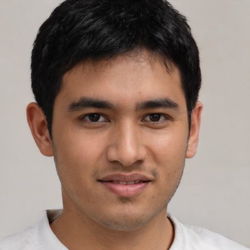 Joyful asian young-adult male with short  black hair and brown eyes