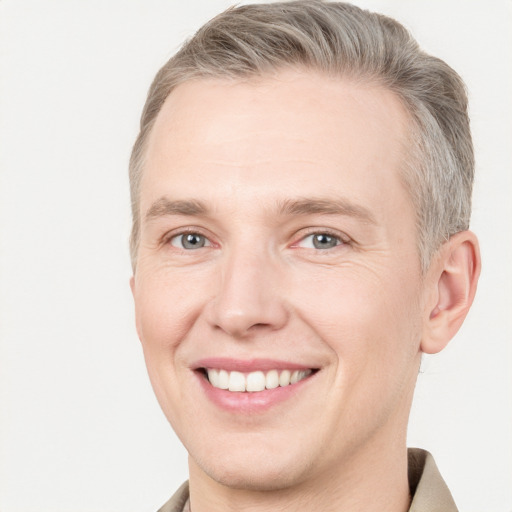 Joyful white adult male with short  brown hair and grey eyes