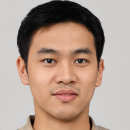 Joyful asian young-adult male with short  black hair and brown eyes