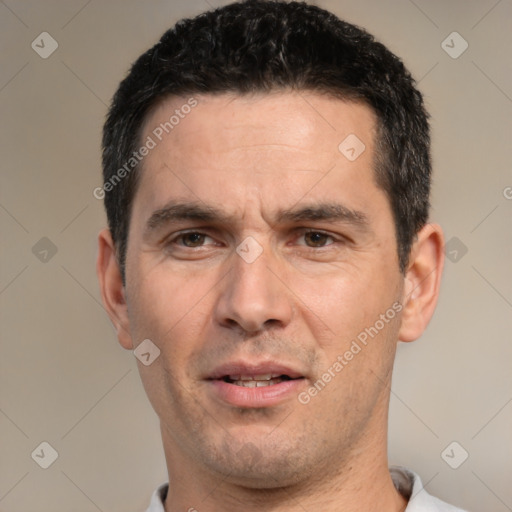 Joyful white adult male with short  black hair and brown eyes