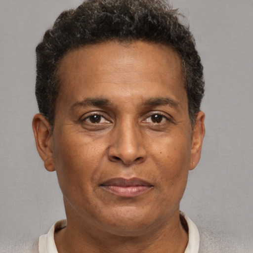 Joyful black adult male with short  brown hair and brown eyes