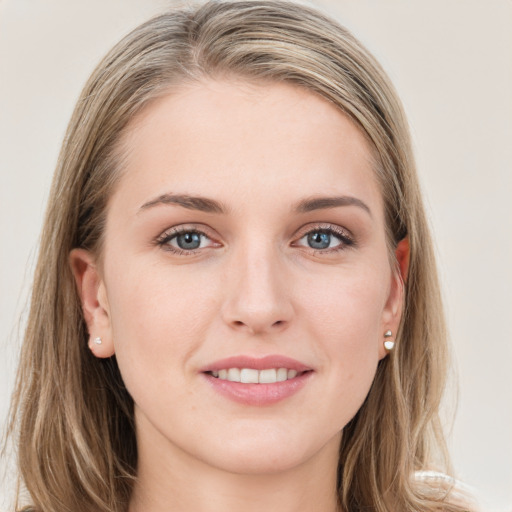 Joyful white young-adult female with long  brown hair and blue eyes