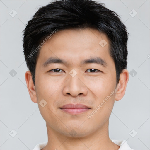 Joyful asian young-adult male with short  black hair and brown eyes