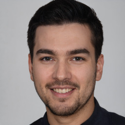 Joyful white young-adult male with short  black hair and brown eyes