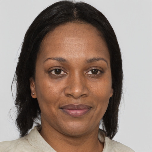 Joyful black adult female with medium  brown hair and brown eyes