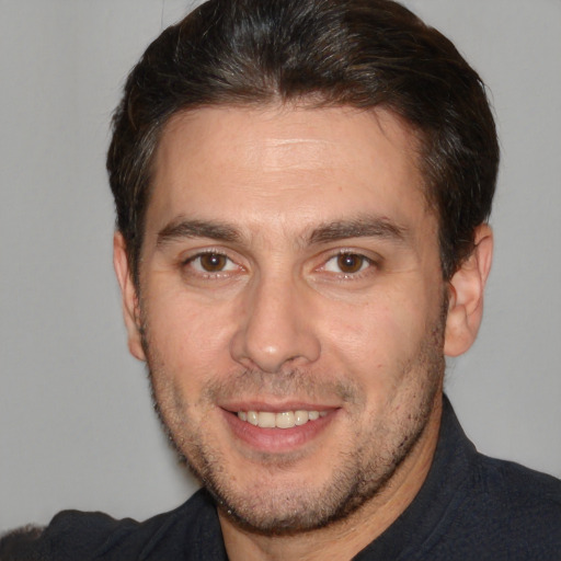 Joyful white adult male with short  brown hair and brown eyes