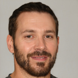 Joyful white adult male with short  brown hair and brown eyes