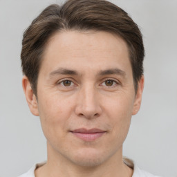 Joyful white adult male with short  brown hair and brown eyes