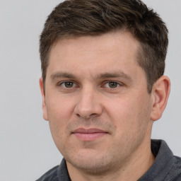 Joyful white adult male with short  brown hair and grey eyes