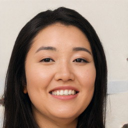 Joyful latino young-adult female with long  black hair and brown eyes