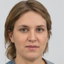 Joyful white adult female with medium  brown hair and grey eyes